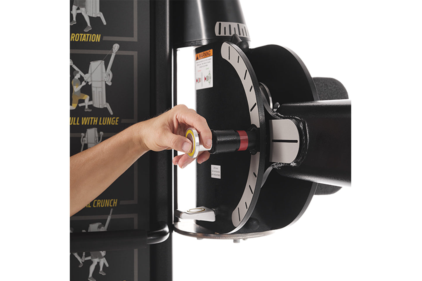 Hand adjusting black and red weight pin on Freemotion Genesis G624 dual cable cross machine with exercise instructions visibl