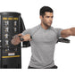 Man in gray t-shirt demonstrating dual cable cross exercise machine with black frame and illustrated workout guides on white 