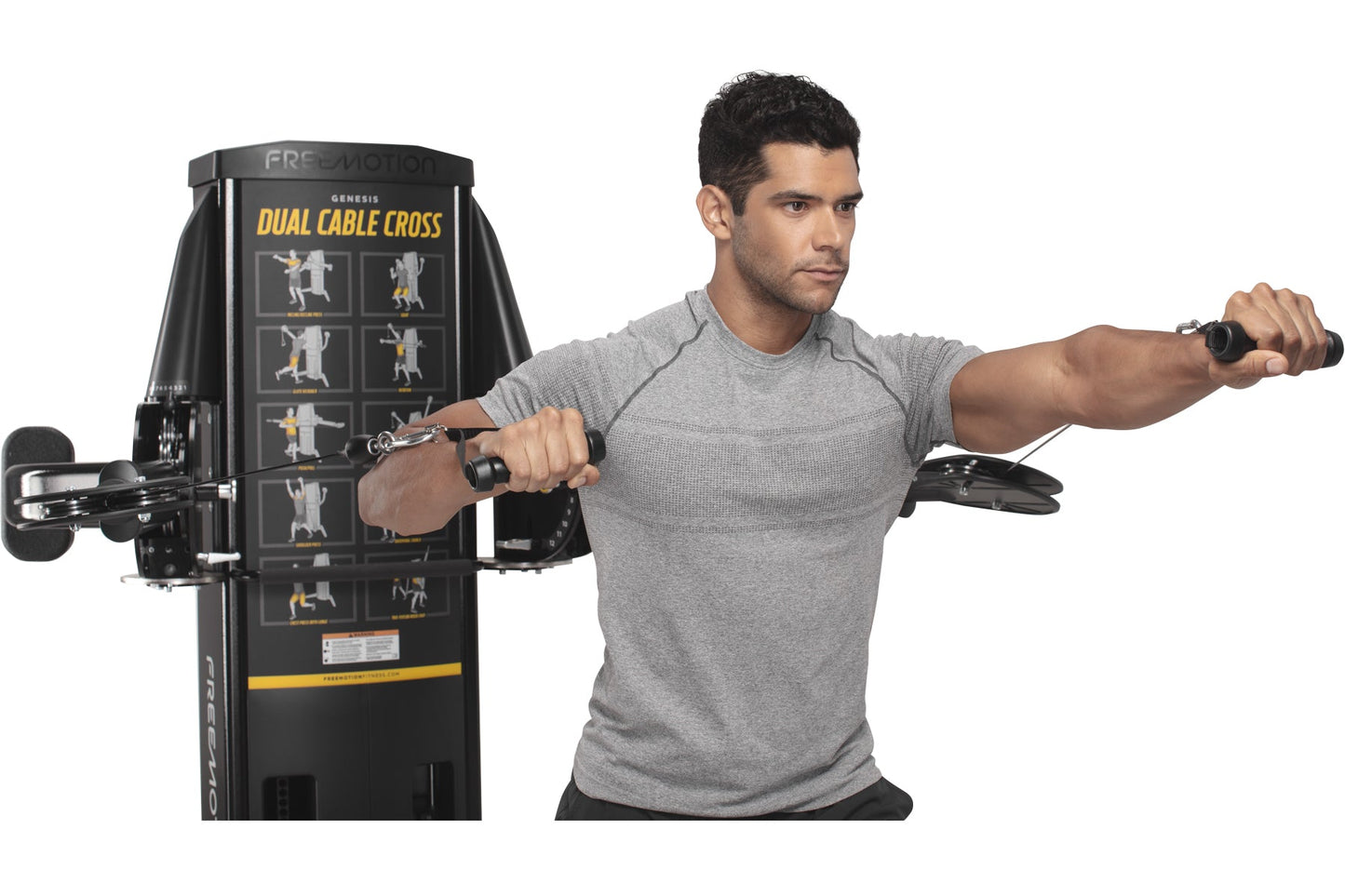 Man in gray t-shirt demonstrating dual cable cross exercise machine with black frame and illustrated workout guides on white 