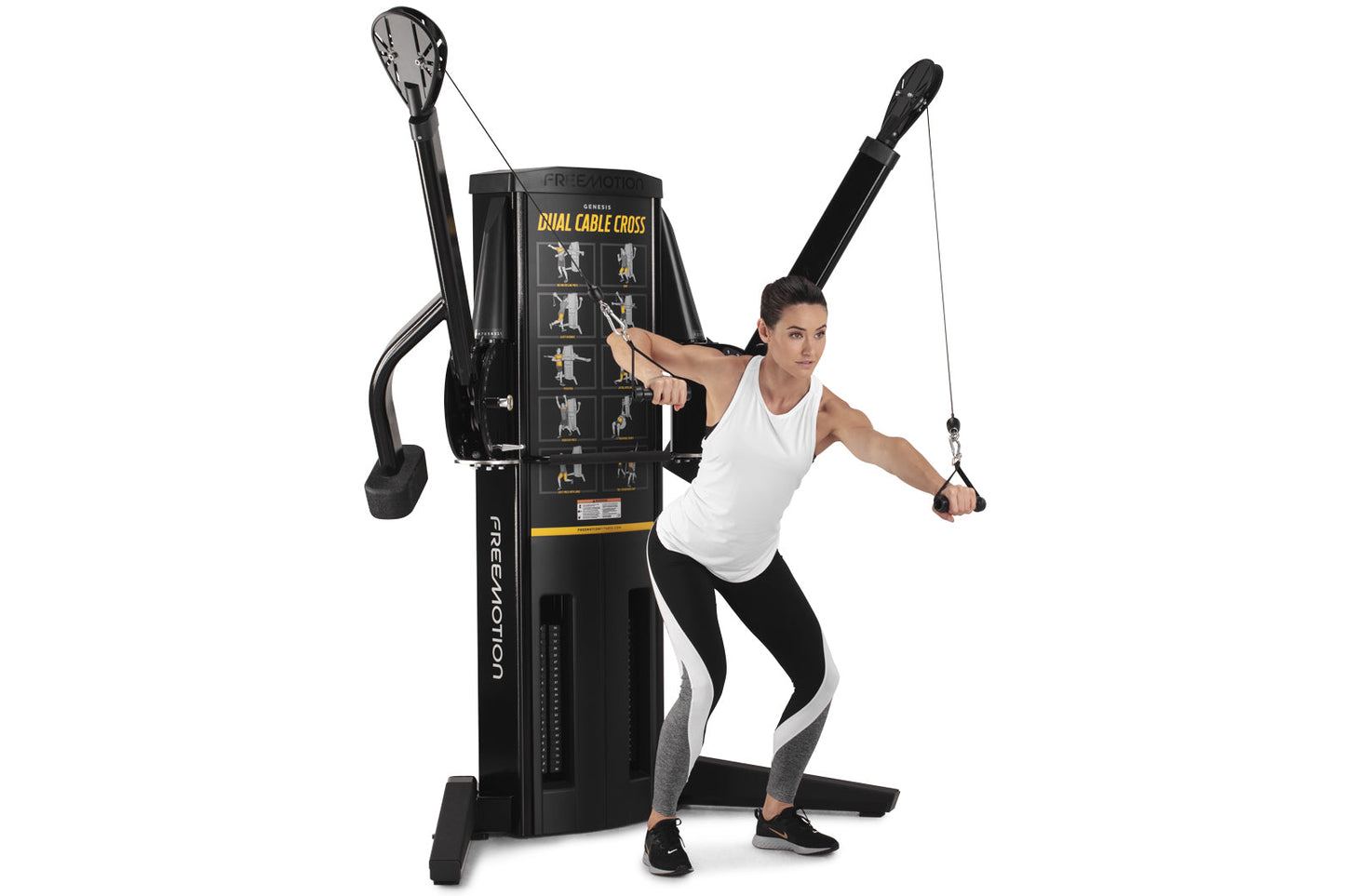 Black Freemotion Genesis Dual Cable Cross machine with dual adjustable pulleys, shown with model demonstrating exercise techn
