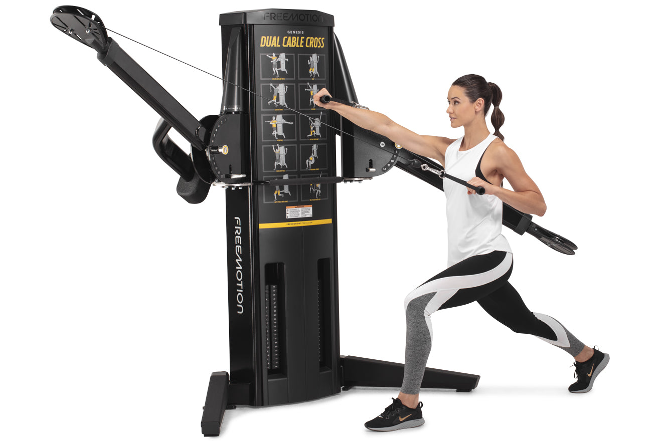 Freemotion Genesis G624 dual cable cross machine in black with instruction chart, demonstrated by woman in white tank top and