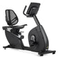 Black recumbent exercise bike with mesh backrest, padded seat, upright digital display, and wheel base on white background