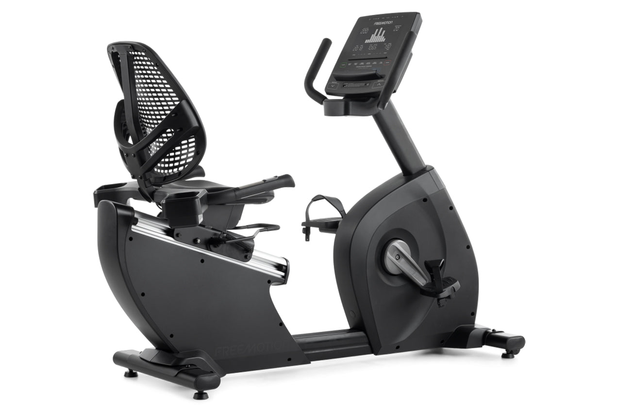 Black recumbent exercise bike with mesh backrest, digital console display, and pedal straps on white background