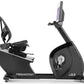 Freemotion r22.9 black recumbent exercise bike with tablet holder and foot pedals, side view on white background