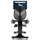 Black recumbent exercise bike with mesh backrest, foot pedals, and mounted tablet display showing fitness content, front view