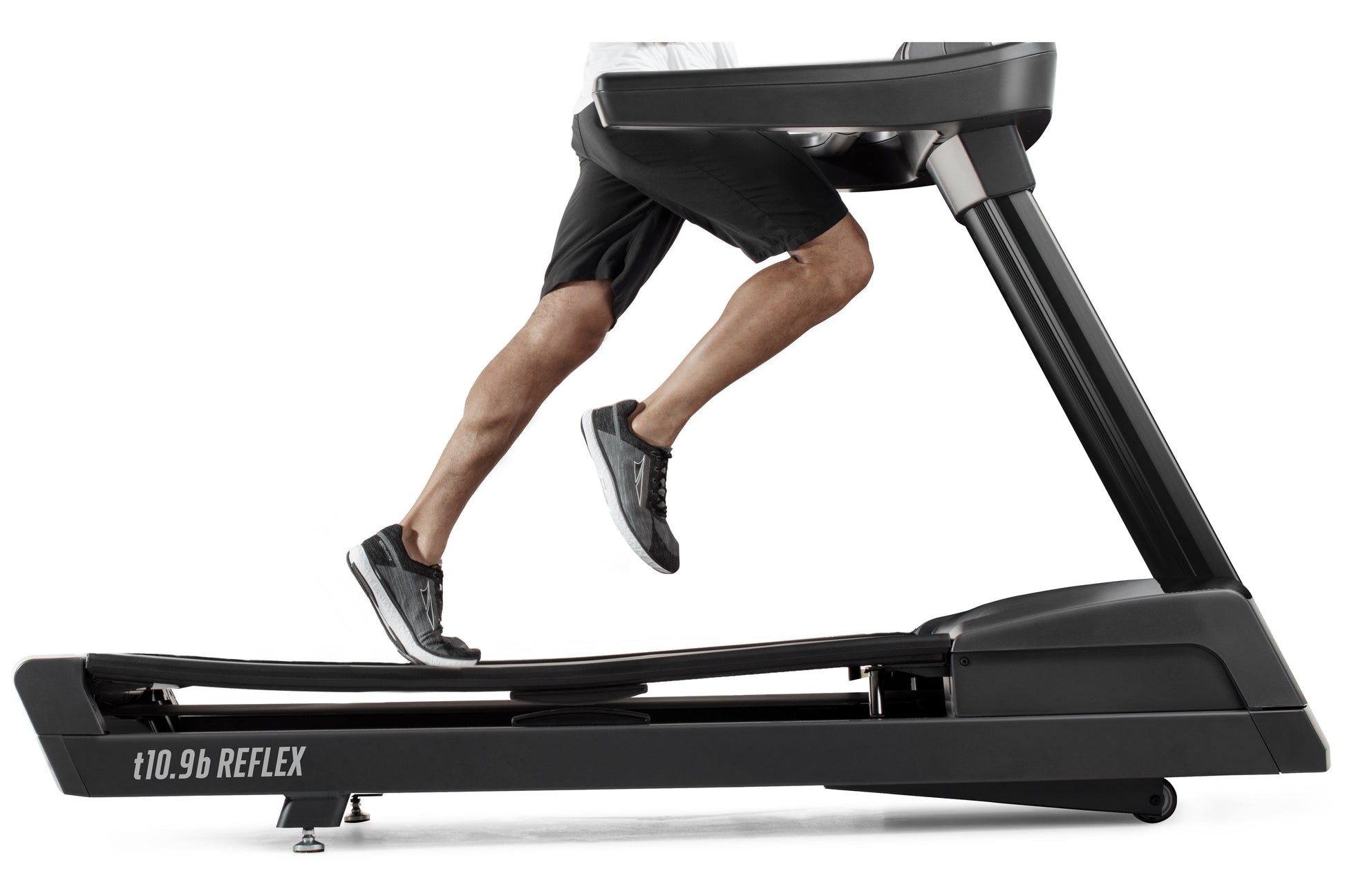 Man running on black t10.9b REFLEX treadmill with digital display, wearing black shorts and gray sneakers