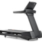 Black Freemotion REFLEX treadmill with digital display console, textured running belt, and curved support frame on white back