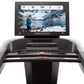 Freemotion t22.9 REFLEX treadmill with black frame, touchscreen display showing mountain running scene, and control panel wit