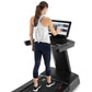 Woman wearing white tank top and navy capri leggings running on black Freemotion treadmill with interactive touchscreen displ