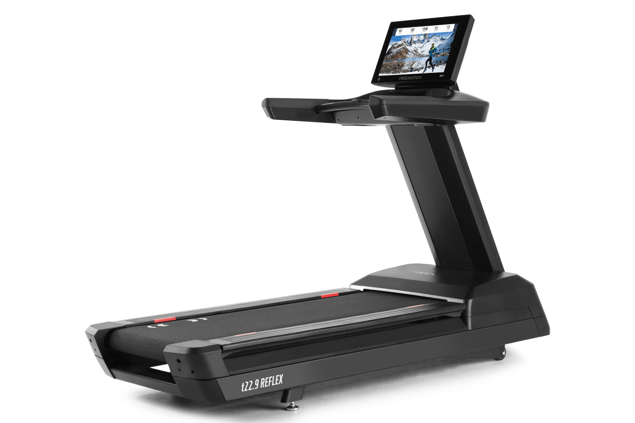 Black Freemotion t22.9 REFLEX treadmill with integrated touchscreen display showing workout content, wide running belt, and s