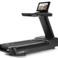 Black commercial treadmill with integrated touchscreen display showing landscape video content, gray accents, and wide runnin