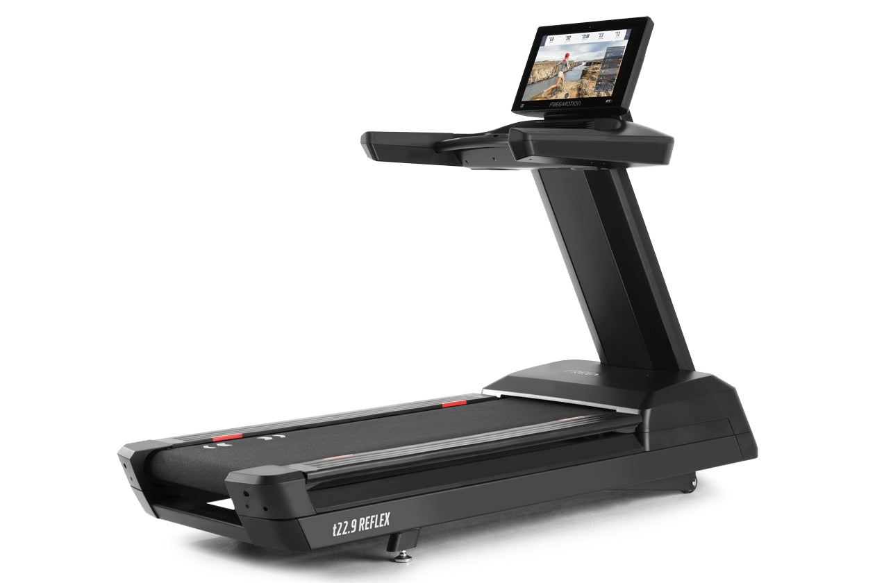 Black commercial treadmill with integrated touchscreen display showing landscape video content, gray accents, and wide runnin