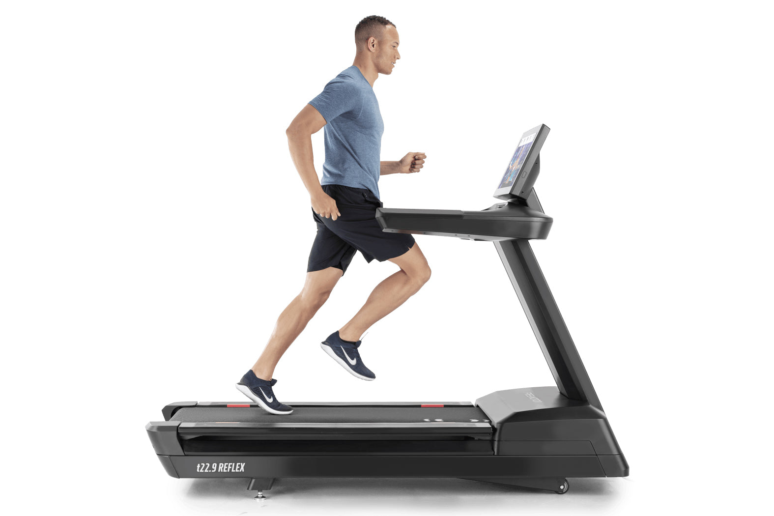 Man running on black t22.9 REFLEX treadmill wearing blue t-shirt and black shorts, white sneakers visible