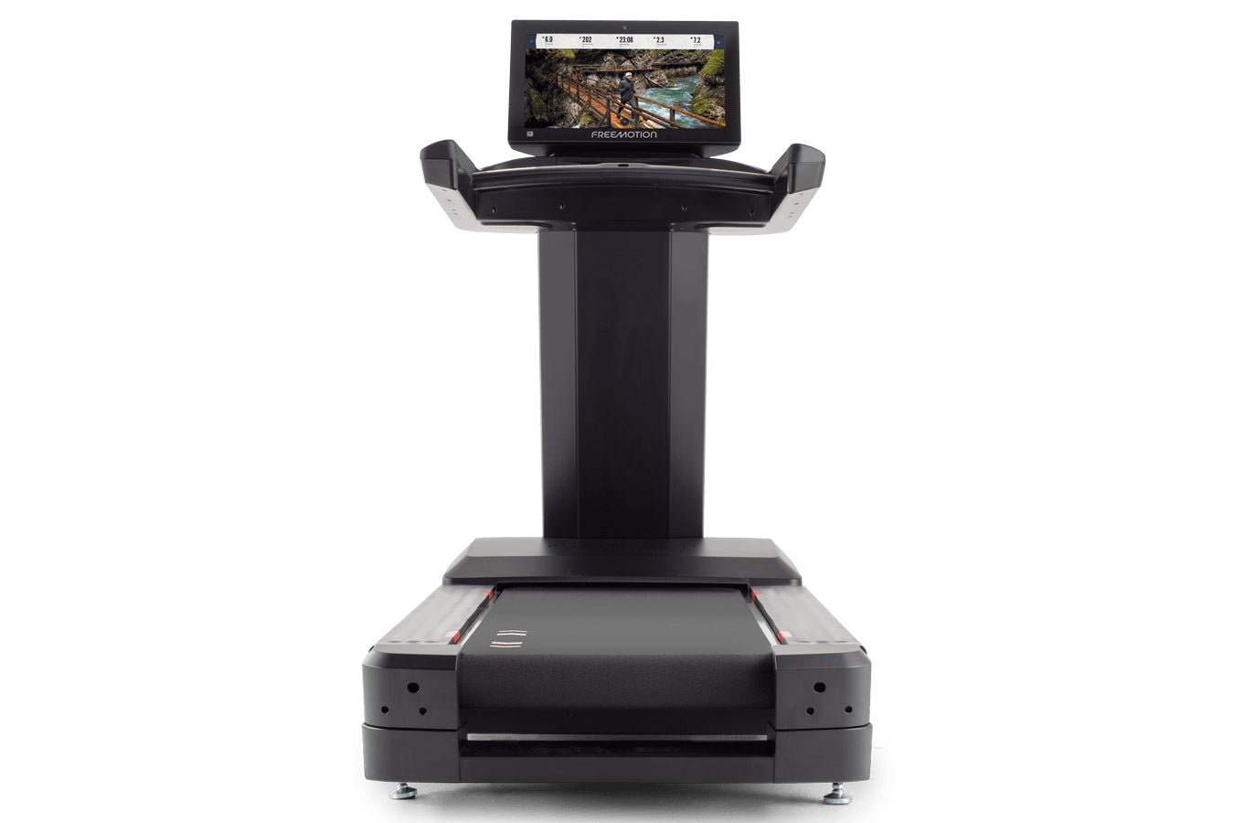 Black Freemotion treadmill with digital display monitor mounted on top showing landscape scenery, featuring wide running deck