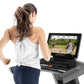 Woman running on Freemotion treadmill with display screen showing workout stats and safari video, worn by model on white back