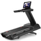 Black Freemotion t22.9 REFLEX treadmill with digital display screen mounted on upright console, shown on white background