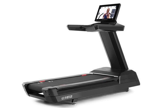 Black Freemotion t22.9 REFLEX treadmill with integrated tablet display mounted on upright console, shown on white background