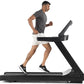 Man running on black Freemotion t8.9b treadmill wearing gray t-shirt and white shorts