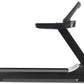 Black Freemotion treadmill with angled running deck, digital display console, and adjustable handrails on white background