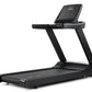 Black Freemotion t8.9b treadmill with digital display console, cushioned running deck, and folding frame on white background