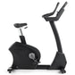 Freemotion U10.9B black upright exercise bike with padded seat, dual handlebars, and digital console on white background
