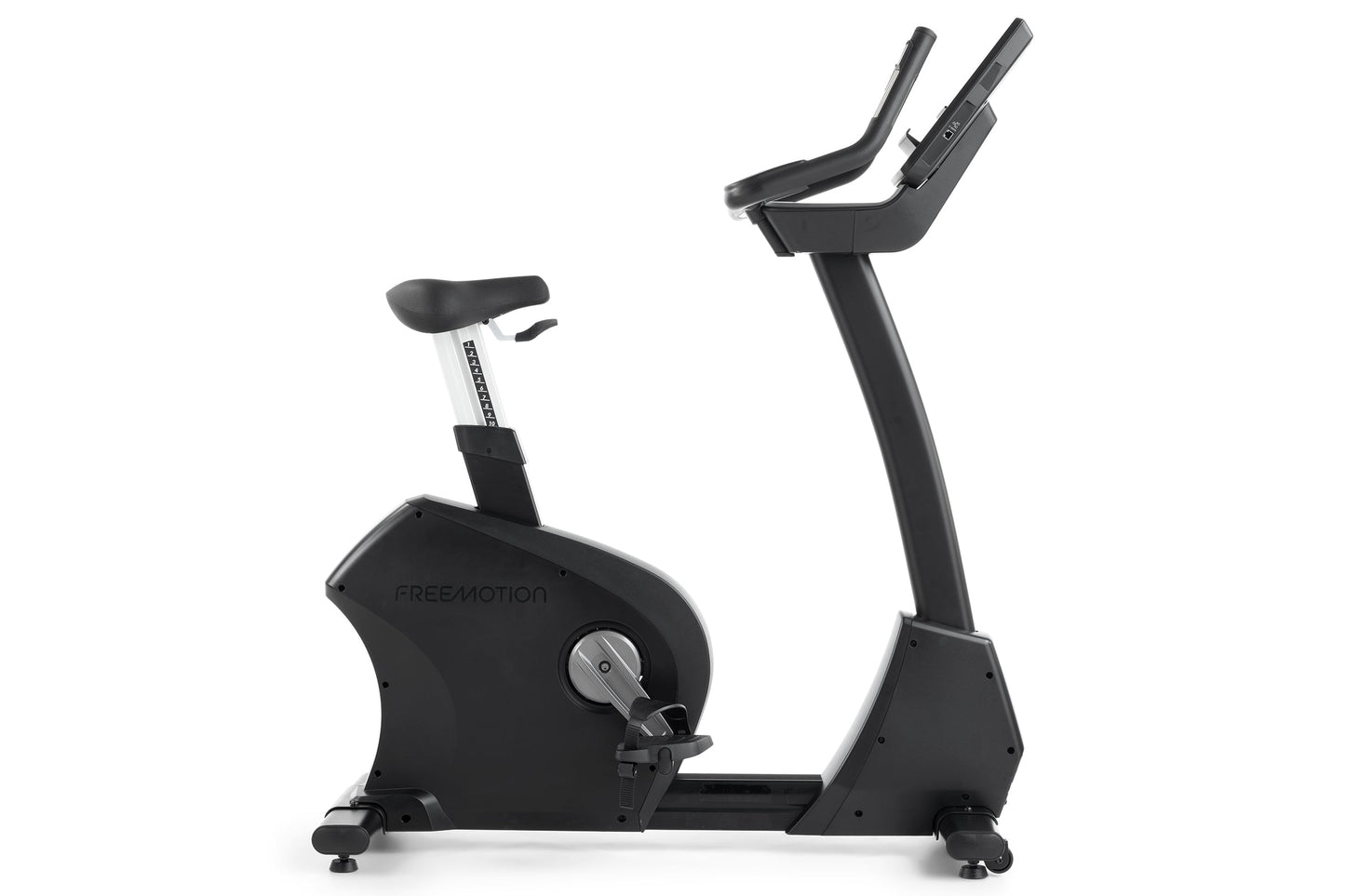 Freemotion U10.9B black upright exercise bike with padded seat, dual handlebars, and digital console on white background