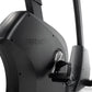Black Freemotion u10.9b upright exercise bike with angular frame and adjustable pedal straps, shown on white background