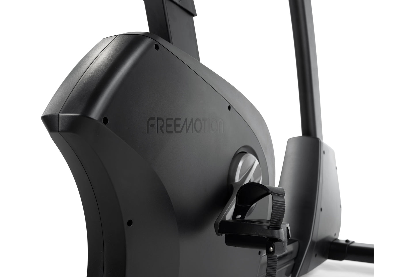Black Freemotion u10.9b upright exercise bike with angular frame and adjustable pedal straps, shown on white background