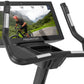 Freemotion u22.9 upright exercise bike with black frame, silver accents, and touchscreen display showing cyclist on mountain 