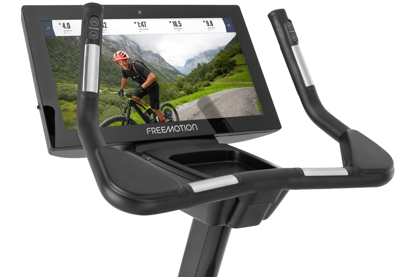 Freemotion u22.9 upright exercise bike with black frame, silver accents, and touchscreen display showing cyclist on mountain 