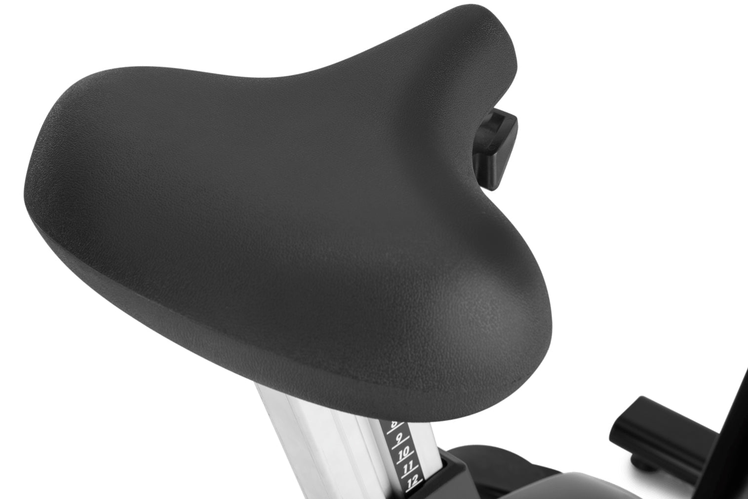 Black padded exercise bike seat with adjustment mechanism and white metal post on white background