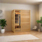 Golden Designs Soria infrared sauna with light wood exterior, glass and wood door panel, interior heater visible, placed in m