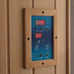 Wood-framed sauna control panel with blue faceplate, red LED temperature display showing 128 degrees and timer display showin