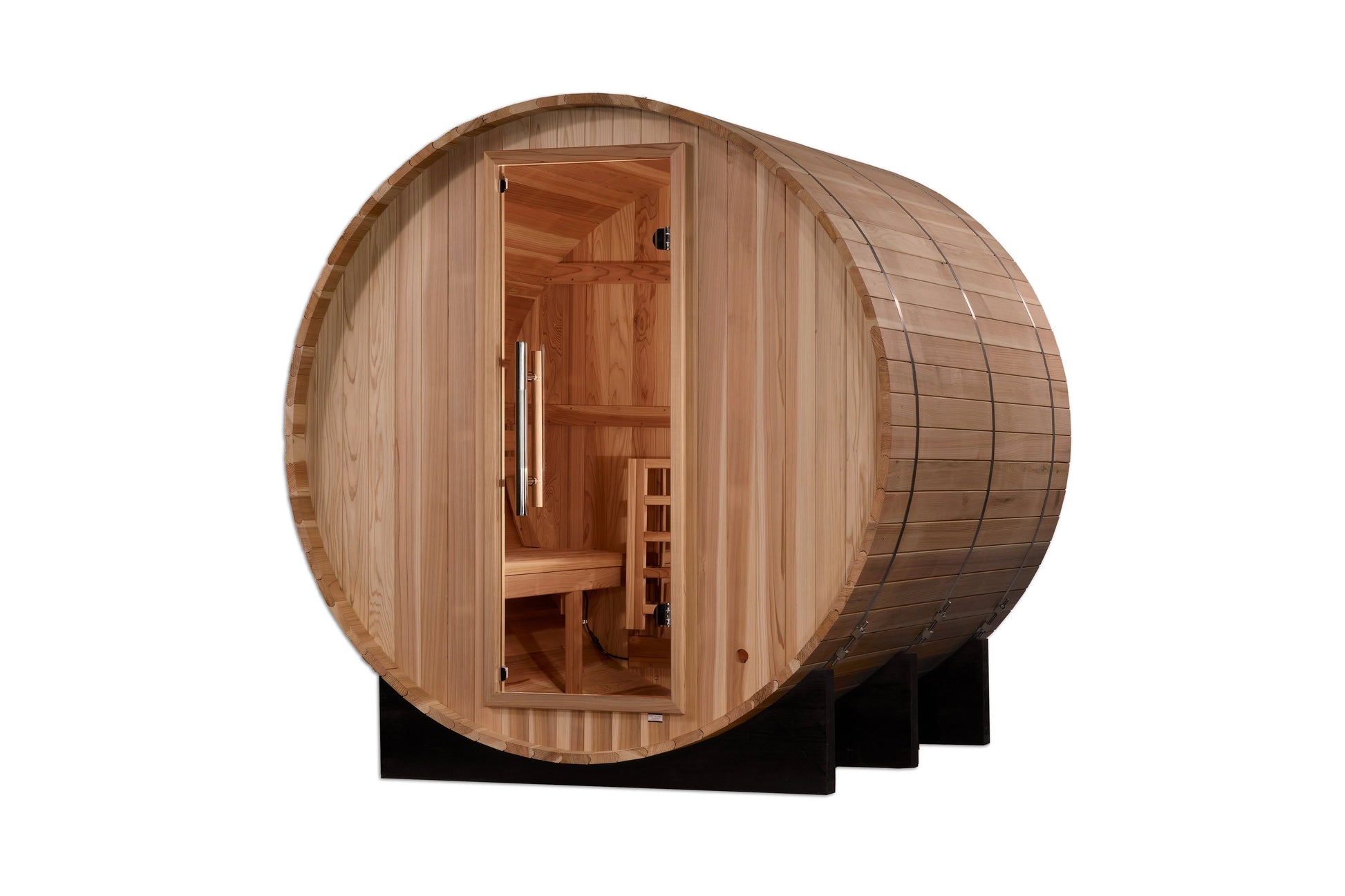 Barrel-shaped wooden sauna with light cedar construction, open door showing interior benches and heater, metal bands around e