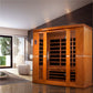 Golden Designs Bergamo four-person infrared sauna with golden wood frame and black glass panels in modern spa room setting