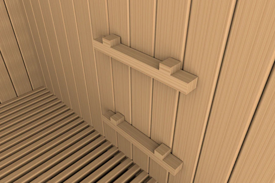 Interior view of sauna with light wood paneling walls, wooden slat floor, and two horizontal wooden handles mounted on wall