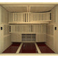 Natural wood sauna interior with light wood slats covering walls and benches, burgundy floor mat, multiple horizontal and ver