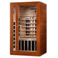 Cedar wood infrared sauna cabin with glass front door, interior wooden benches, heating elements, and control panel on white 
