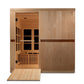 Light wood infrared sauna cabin with glass door, interior benches, recessed ceiling lights, and wooden ramp entrance on white