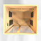 Golden Designs Serena 2-person far infrared sauna interior view with wood paneling, four black vents, and warm yellow lightin