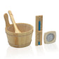 Wooden sauna bucket with ladle, wooden thermometer with blue markers, and analog hygrometer on white background, flat lay