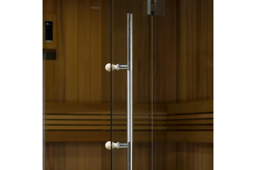 Glass sauna door with chrome handles and white porcelain knobs on wood-paneled sauna exterior
