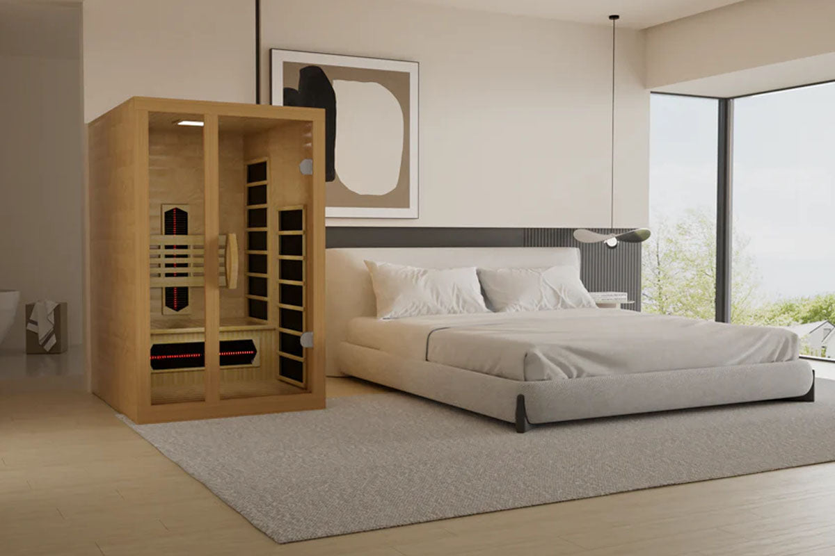 Golden Designs Gracia sauna with light wood construction and glass doors in modern bedroom setting with bed