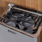 Harvia sauna heater with black metal casing and gray heating stones visible in open compartment, mounted on wood wall backgro