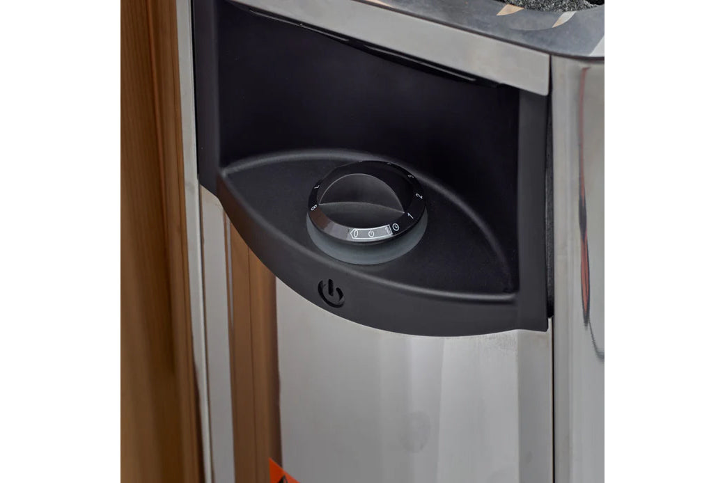 Black and silver control panel with rotary dial and power button on hybrid outdoor sauna exterior