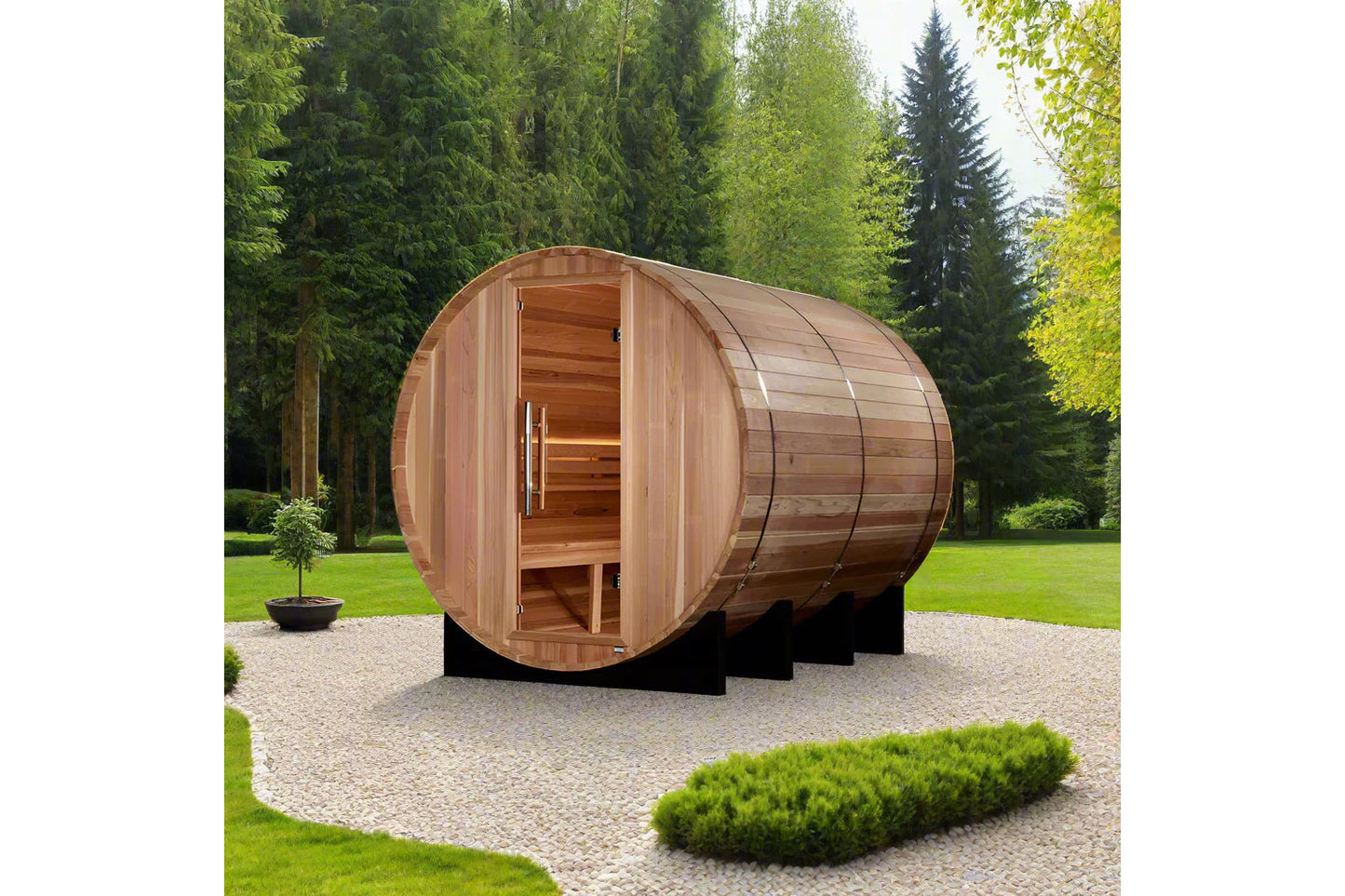 Golden Designs Klosters barrel sauna in red cedar with open door, showing wooden interior benches, in garden setting with eve
