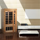Golden Designs two-person infrared sauna with cedar wood exterior, glass double doors, and black interior panels in modern li