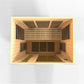 Interior view of wooden sauna cabin with light wood construction, black heating elements, and warm yellow lighting on white b