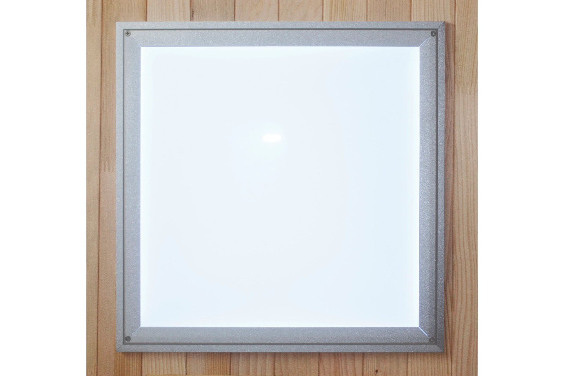 Silver-framed white square mirror with metal corners mounted on light wood wall