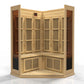 Natural wood corner sauna with vertical slat panels, wooden benches, lower ventilation louvers, and control panel, on white b